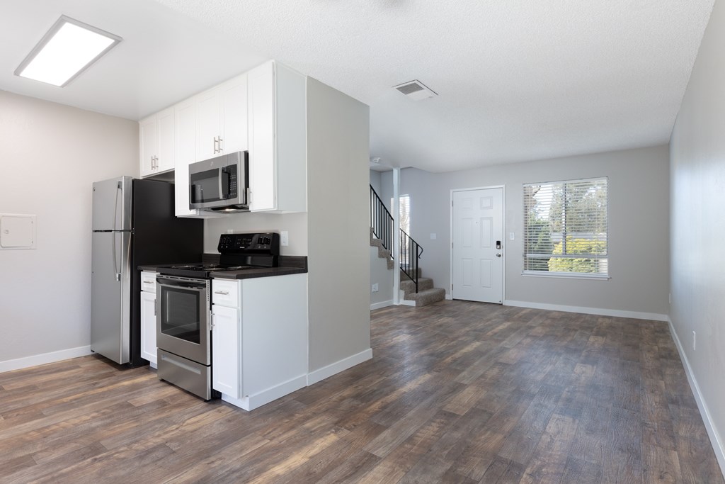 a kitchen and living room in a two bedroom apartment
